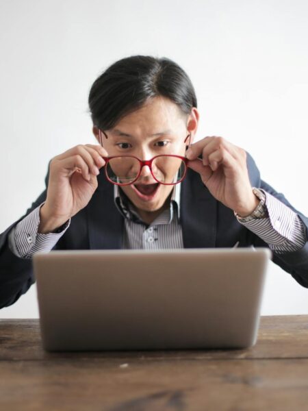 amazed formal male looking at laptop screen